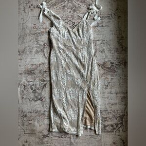 Worn once, small tear on the front lace and some discoloration by the slit